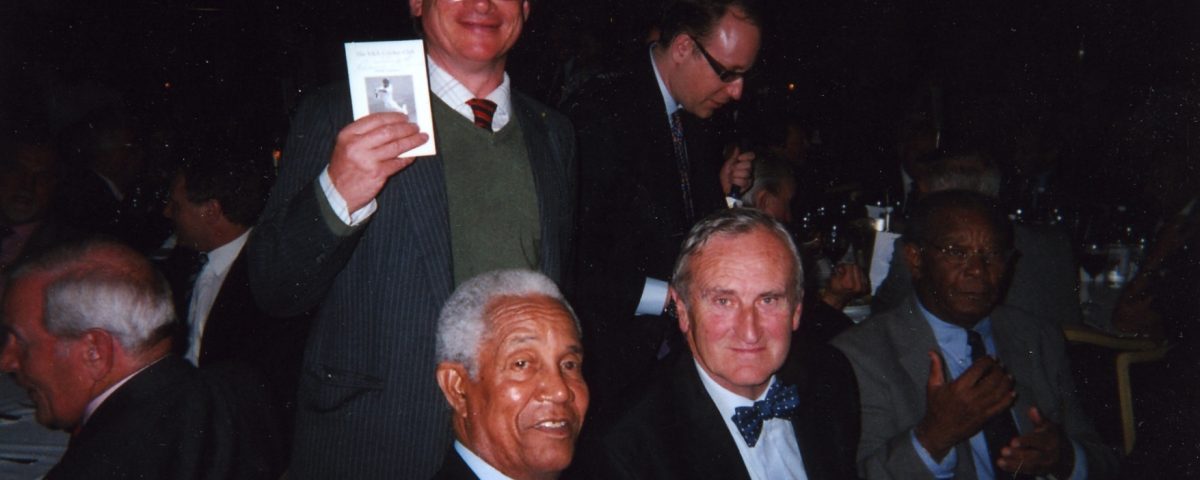 Nick Bird (above, headless) holding the 2006 Fixture Card with its cover featuring Sir Garry Sobers, who is seated with Ted Dexter at a Hilton Hotel function. Ted seemed a bit confused and didn't recall his status as our President, but it was late and the evening had been convivial.